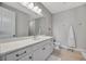 Modern bathroom featuring a large mirror, white vanity, and elegant fixtures at 6027 White Mangrove Ln, Bradenton, FL 34210