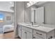 Well-lit bathroom with a white vanity, framed mirror, and white marble countertops at 6027 White Mangrove Ln, Bradenton, FL 34210