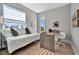 Comfortable bedroom with a desk, modern décor, and lots of natural light at 6027 White Mangrove Ln, Bradenton, FL 34210