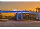 The entrance to IMG Academy with blue lights, signs, and a street at 6027 White Mangrove Ln, Bradenton, FL 34210