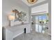 Entryway with gray tile flooring, a modern console table, stylish decor and bright lighting at 6027 White Mangrove Ln, Bradenton, FL 34210