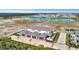 An aerial view of a modern townhouse community with a lake at 6027 White Mangrove Ln, Bradenton, FL 34210
