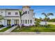 Beautiful two-story home with a turret, lush landscaping, dark trim and a well-manicured lawn at 6027 White Mangrove Ln, Bradenton, FL 34210