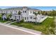Charming, bright white two-story home featuring an outdoor patio and meticulous landscaping at 6027 White Mangrove Ln, Bradenton, FL 34210