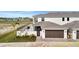 An exterior view of a modern two-story house featuring a fenced-in patio and a two-car garage at 6027 White Mangrove Ln, Bradenton, FL 34210