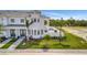 A modern white two-story house with landscaping and a view of a lake at 6027 White Mangrove Ln, Bradenton, FL 34210