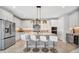 Modern kitchen boasts stainless steel appliances, a stylish island, and sleek white cabinetry at 6027 White Mangrove Ln, Bradenton, FL 34210