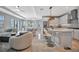 Spacious open-concept living room features a kitchen, dining area, and stylish modern decor at 6027 White Mangrove Ln, Bradenton, FL 34210