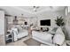 Bright, open-concept living room leading into a modern kitchen with a kitchen island and bar seating at 6027 White Mangrove Ln, Bradenton, FL 34210