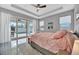 Bright bedroom with a ceiling fan, outdoor views, and a sliding glass door to the pool at 6027 White Mangrove Ln, Bradenton, FL 34210