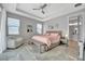 A cozy bedroom with a ceiling fan, ample natural light, and stylish decor at 6027 White Mangrove Ln, Bradenton, FL 34210