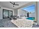 Outdoor patio featuring modern furniture, a sleek hot tub, and a refreshing pool for relaxation and entertainment at 6027 White Mangrove Ln, Bradenton, FL 34210