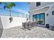 Relaxing outdoor patio with modern dining furniture and ceiling fans for comfortable entertaining at 6027 White Mangrove Ln, Bradenton, FL 34210