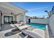 The pristine backyard features a sparkling pool, sun loungers, and plenty of space for relaxation at 6027 White Mangrove Ln, Bradenton, FL 34210