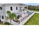 Rear exterior elevation with an upper balcony, a ground-level patio, and a private swimming pool at 6027 White Mangrove Ln, Bradenton, FL 34210