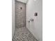 Walk-in shower featuring designer tile, rainfall shower head, and convenient shelving at 6027 White Mangrove Ln, Bradenton, FL 34210