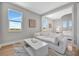 Bright sitting room with comfortable white sofa, adjacent to a bedroom at 6027 White Mangrove Ln, Bradenton, FL 34210