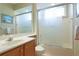 Clean bathroom featuring a glass-enclosed shower, vanity with sink, and neutral tiling at 6103 Aviary Ct, Bradenton, FL 34203