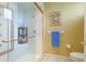 Bathroom with tiled shower and glass door, complemented by a towel rack and toilet at 6103 Aviary Ct, Bradenton, FL 34203