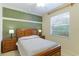 Comfortable bedroom with a large window, a queen-sized bed, and matching nightstands with lamps at 6103 Aviary Ct, Bradenton, FL 34203