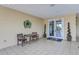 Clubhouse entrance with chairs, logo signage, double-door entry, and decorative plants at 6103 Aviary Ct, Bradenton, FL 34203