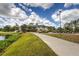 Beautiful clubhouse view with golf carts and pond, all in a serene and picturesque setting at 6103 Aviary Ct, Bradenton, FL 34203