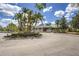 Community clubhouse with lush landscaping, circular driveway and prominent signage at 6103 Aviary Ct, Bradenton, FL 34203