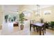 Open dining area features modern light fixture, tile floors, and access to the living spaces at 6103 Aviary Ct, Bradenton, FL 34203