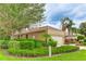 Well-maintained exterior featuring a lush green lawn and meticulously trimmed hedges at 6103 Aviary Ct, Bradenton, FL 34203