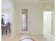 Bright foyer with decorative front door, neutral tile flooring, and access to the dining area at 6103 Aviary Ct, Bradenton, FL 34203