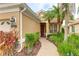 Inviting home exterior with a brick walkway leading to the front door, complimented by lush landscaping at 6103 Aviary Ct, Bradenton, FL 34203