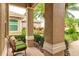 Cozy front porch with a wicker chair overlooking the lush landscaping and brick-paved walkway at 6103 Aviary Ct, Bradenton, FL 34203