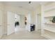 Hallway featuring neutral walls and flooring, leading to various rooms, with ample natural light at 6103 Aviary Ct, Bradenton, FL 34203