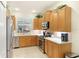 Charming kitchen with stainless steel appliances, wood cabinetry, and bright countertops at 6103 Aviary Ct, Bradenton, FL 34203