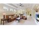 Bright living room featuring a ceiling fan, recessed lighting, and neutral-toned decor at 6103 Aviary Ct, Bradenton, FL 34203