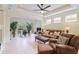 Spacious living room with comfortable seating, tile floors, and natural light from french doors at 6103 Aviary Ct, Bradenton, FL 34203