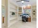 Bright home office with custom shelving, a large window, and a dedicated workspace at 6103 Aviary Ct, Bradenton, FL 34203