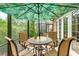 Outdoor patio with a dining set under a large umbrella, perfect for entertaining or relaxation at 6103 Aviary Ct, Bradenton, FL 34203