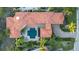 Aerial of the roof highlighting the pool, patio and lush landscaping at 612 Weston Pointe Ct, Longboat Key, FL 34228
