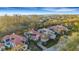 Stunning aerial view of residences with red tile roofs amidst lush greenery in an exclusive community at 612 Weston Pointe Ct, Longboat Key, FL 34228