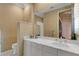 Bright bathroom with a large mirror and white vanity featuring marble countertop at 612 Weston Pointe Ct, Longboat Key, FL 34228