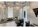 An elegant bathroom boasts a striking black vanity, decorative mirrors, and stylish light fixtures at 612 Weston Pointe Ct, Longboat Key, FL 34228