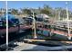 View of a boat dock with several boats covered and tied to the slips at 612 Weston Pointe Ct, Longboat Key, FL 34228