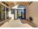 Home entrance featuring decorative glass double doors, brick pavers and palm trees at 612 Weston Pointe Ct, Longboat Key, FL 34228