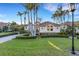 Beautiful home featuring lush landscaping, a tile roof, and a circular driveway at 612 Weston Pointe Ct, Longboat Key, FL 34228