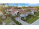 Beautiful home featuring lush landscaping, a circular driveway and a classic red tiled roof at 612 Weston Pointe Ct, Longboat Key, FL 34228