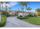 Stunning home featuring lush landscaping, a tile roof, and a circular driveway at 612 Weston Pointe Ct, Longboat Key, FL 34228