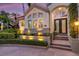 Elegant home entrance with brick steps, manicured bushes, and a decorative door at 612 Weston Pointe Ct, Longboat Key, FL 34228