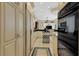 Spacious kitchen with adjacent living area and stainless steel appliances at 612 Weston Pointe Ct, Longboat Key, FL 34228