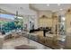 Gourmet kitchen with black granite countertops and breakfast nook overlooking the pool at 612 Weston Pointe Ct, Longboat Key, FL 34228